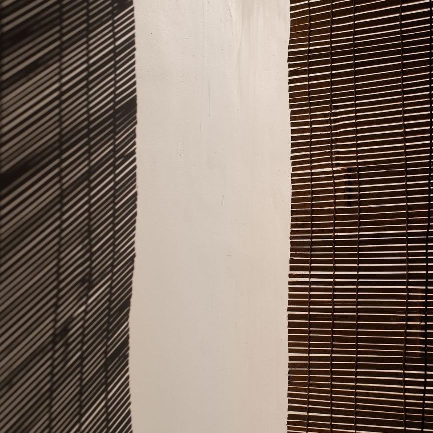 abstract light and shadow on striped blinds